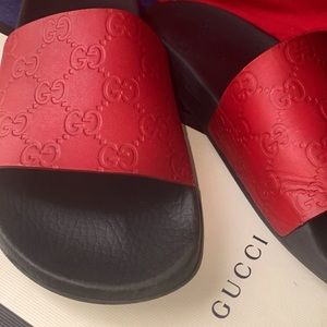Gucci red slides.